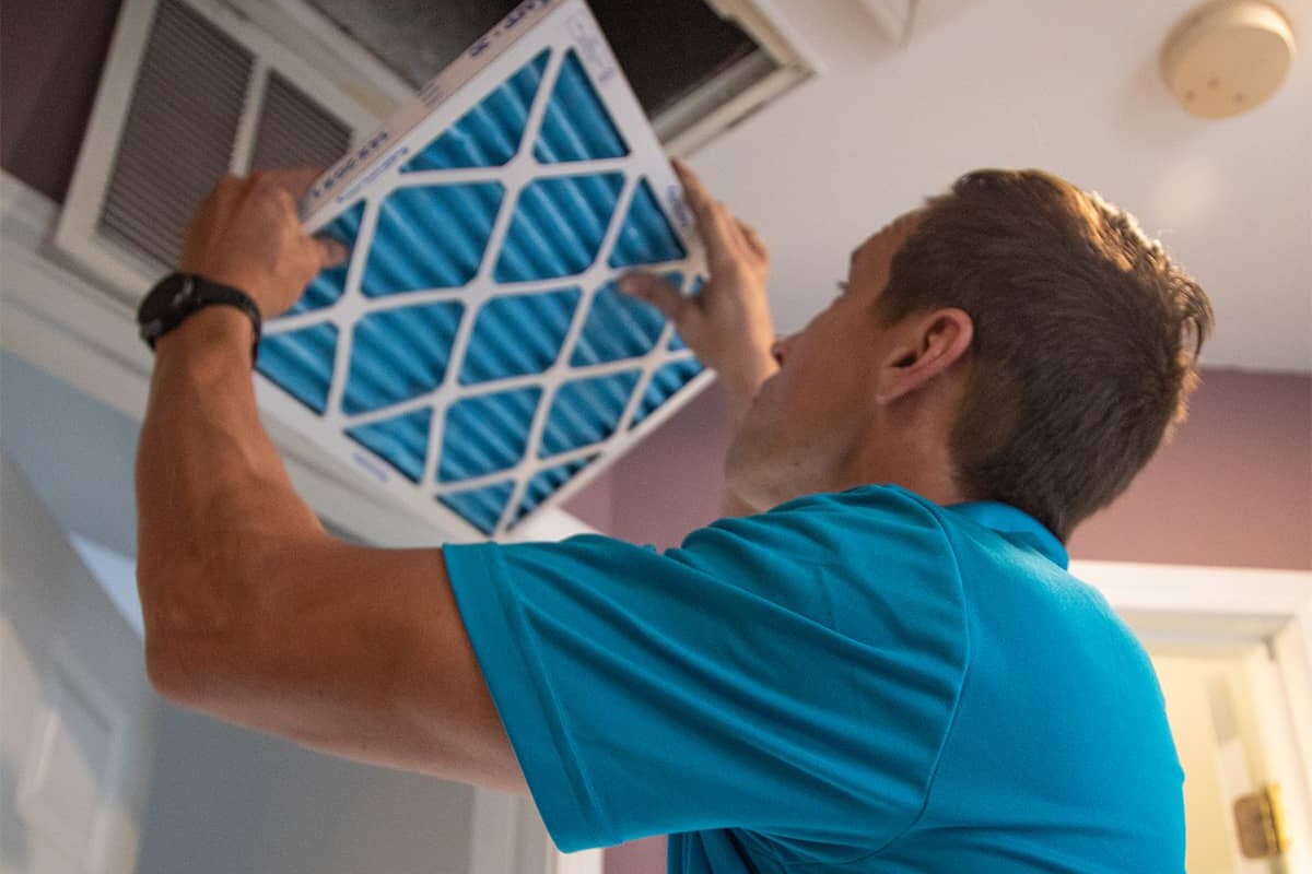 man in blue shirt installing a filter