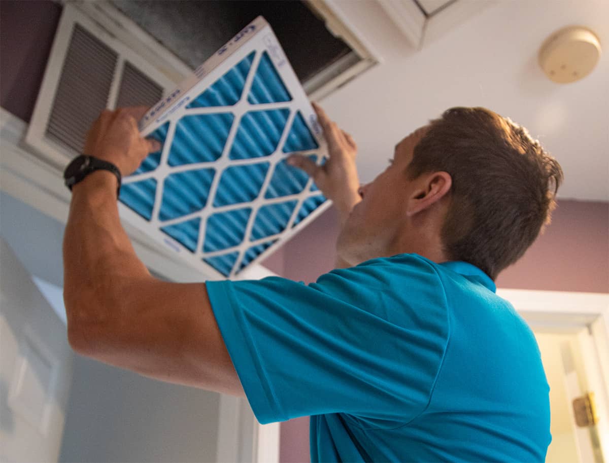 man in blue shirt installing a filter