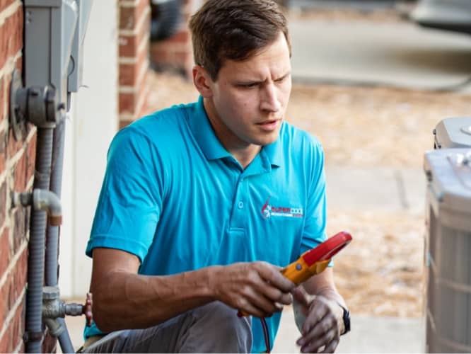 man working outside on business AC unit