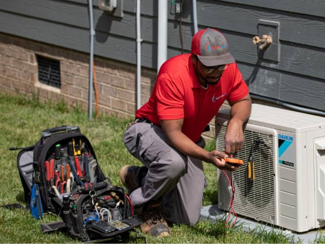 Man working on outdoor AC unit