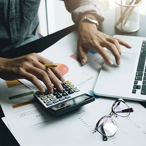 main with calculator and laptop balancing the budget