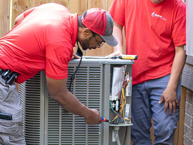 Super Cool Air Conditioning & Heating workers working on an hvac unit